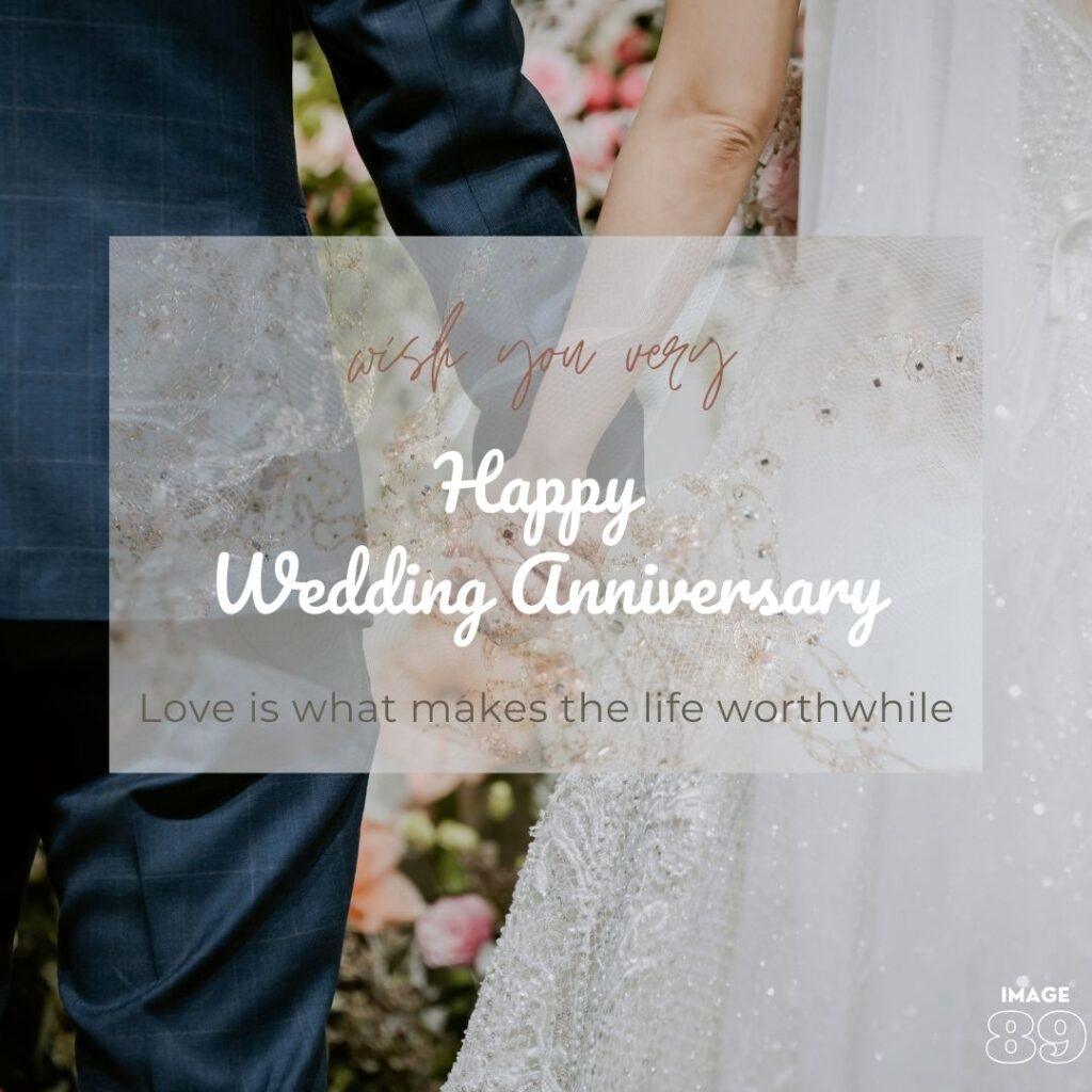 a man in blue tuxedo and a women in white gown holding hand with beautiful flower background Happy Wedding Anniversary image