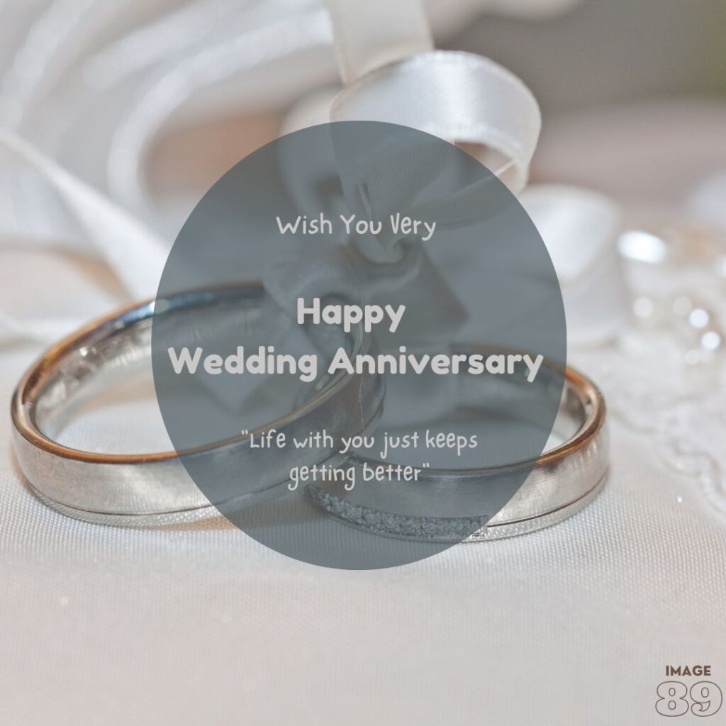 two diamond platinum couple rings knotted in a white satin ribbon with white petals background wedding anniversary image with love quote