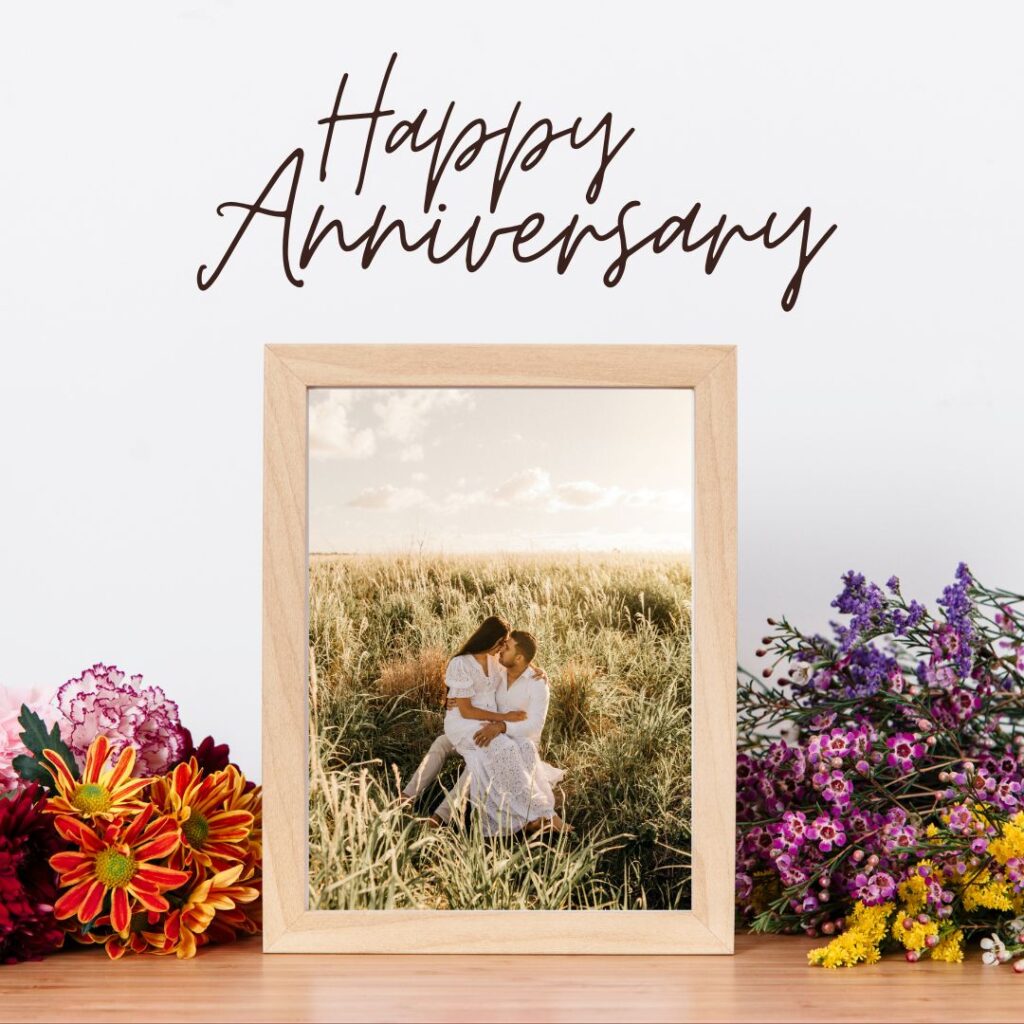 flowery background with a photo frame a couple is kissing in a photo happy anniversary image